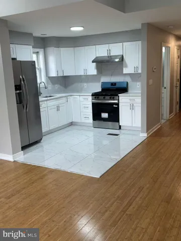 a kitchen with stainless steel appliances granite countertop a refrigerator sink and stove