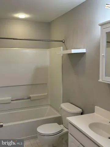 a bathroom with a toilet a sink and shower