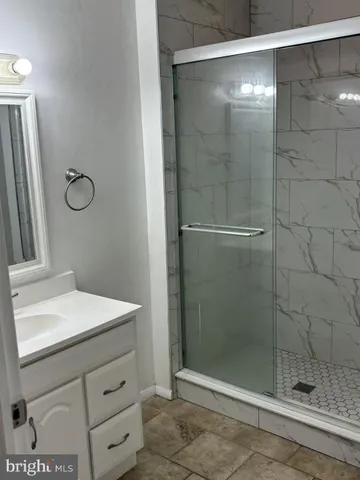 a bathroom with a shower and sink