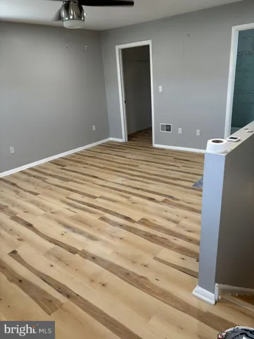 a view of a room with stairs and wooden floor