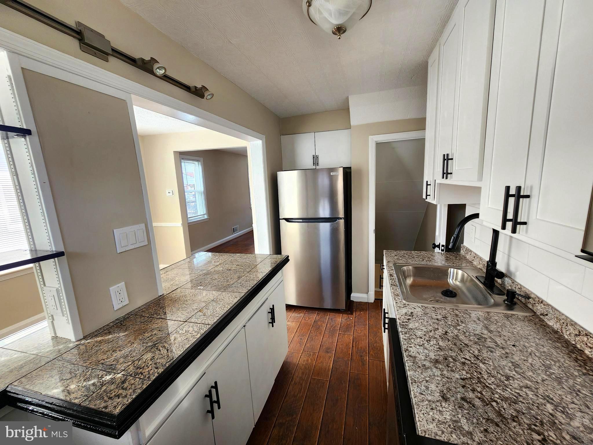 1925 Ewald Avenue Baltimore, MD 21222 - Photo 12 of 29 a view of a kitchen with a sink and refrigerator