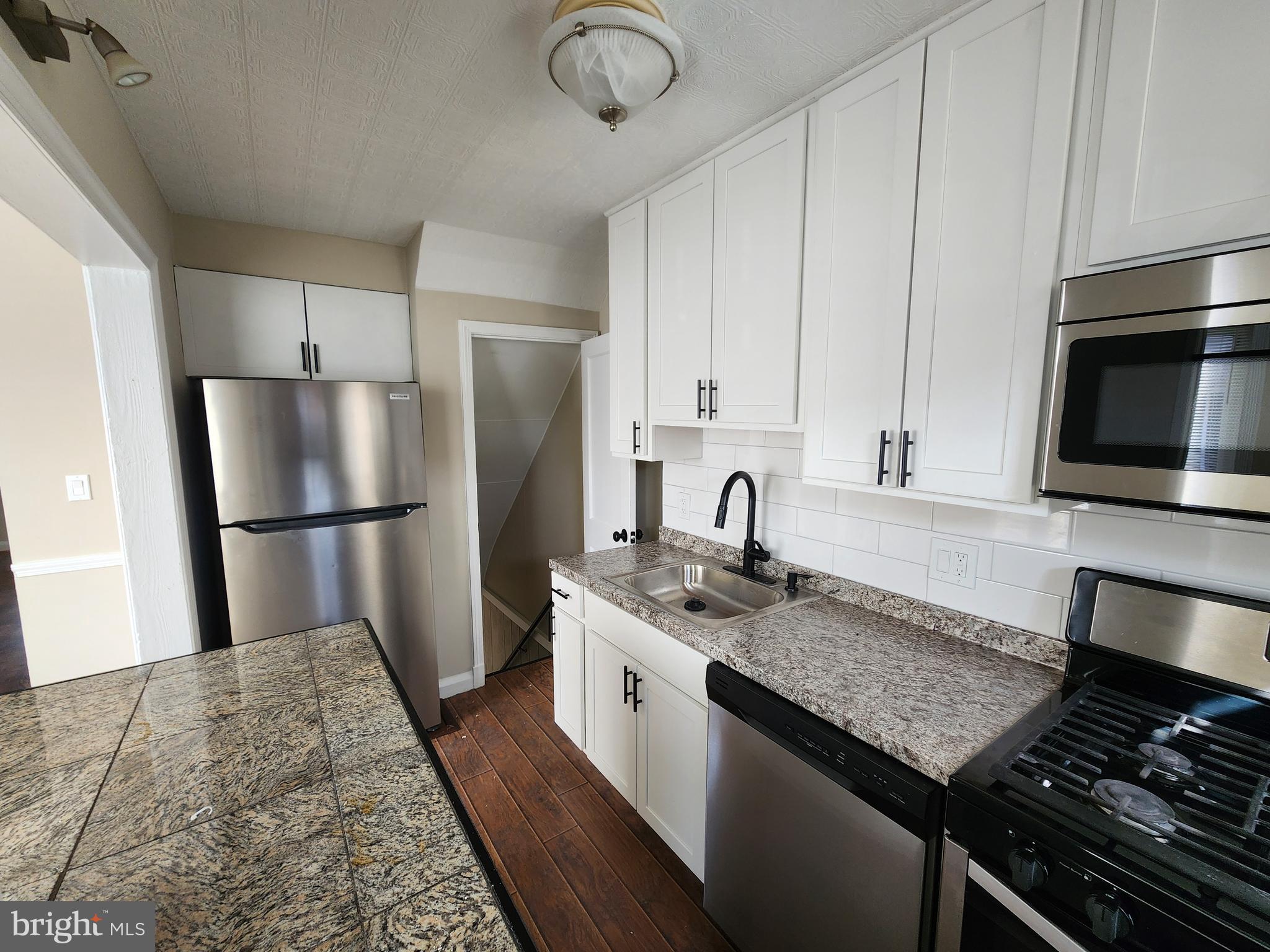 1925 Ewald Avenue Baltimore, MD 21222 - Photo 13 of 29 a kitchen with stainless steel appliances granite countertop a refrigerator a stove and a sink