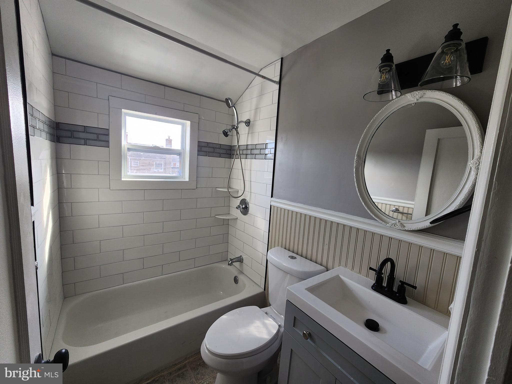 1925 Ewald Avenue Baltimore, MD 21222 - Photo 25 of 29 a bathroom with a sink a toilet and shower