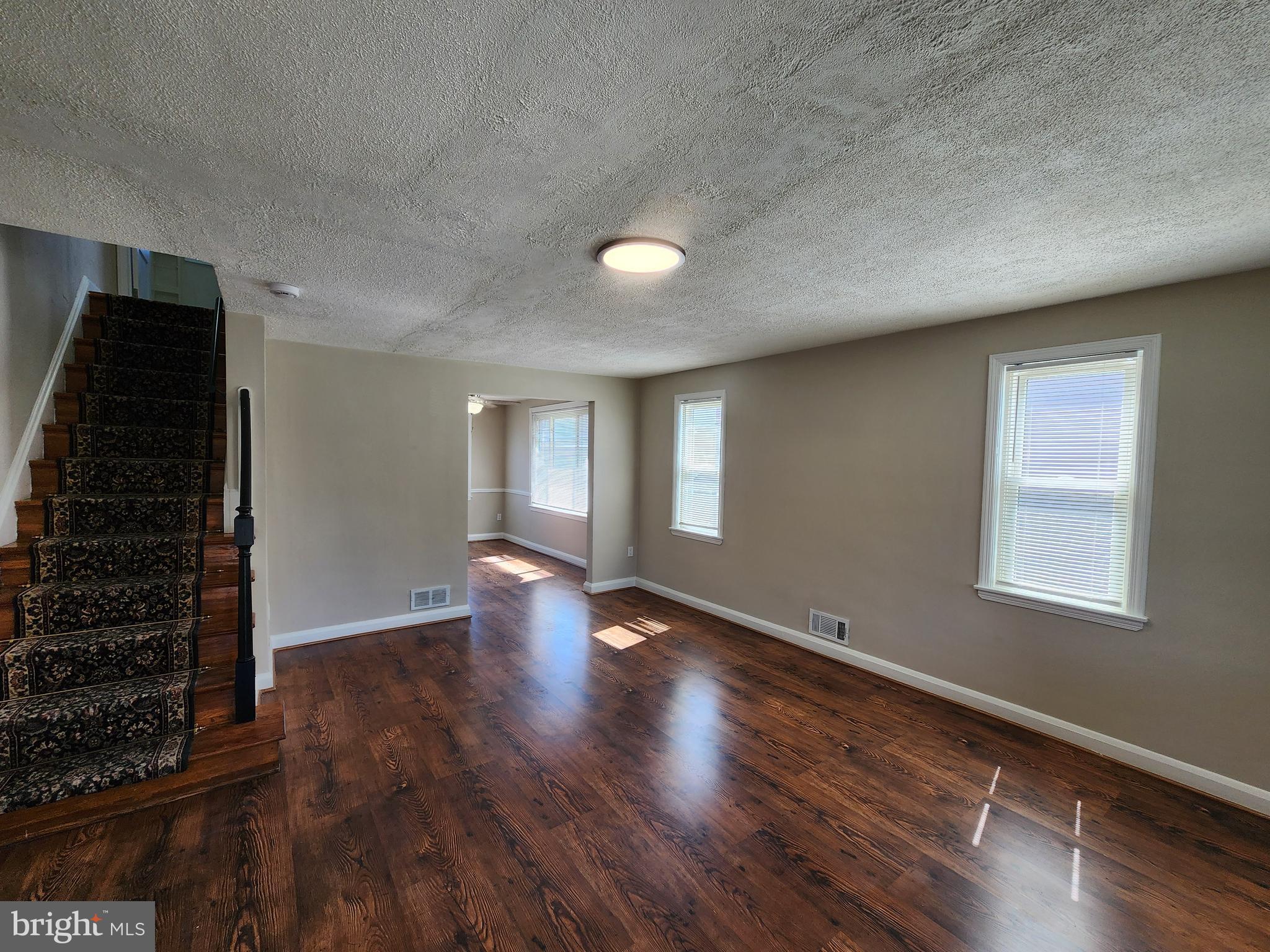 1925 Ewald Avenue Baltimore, MD 21222 - Photo 3 of 29 wooden floor in an empty room with a window