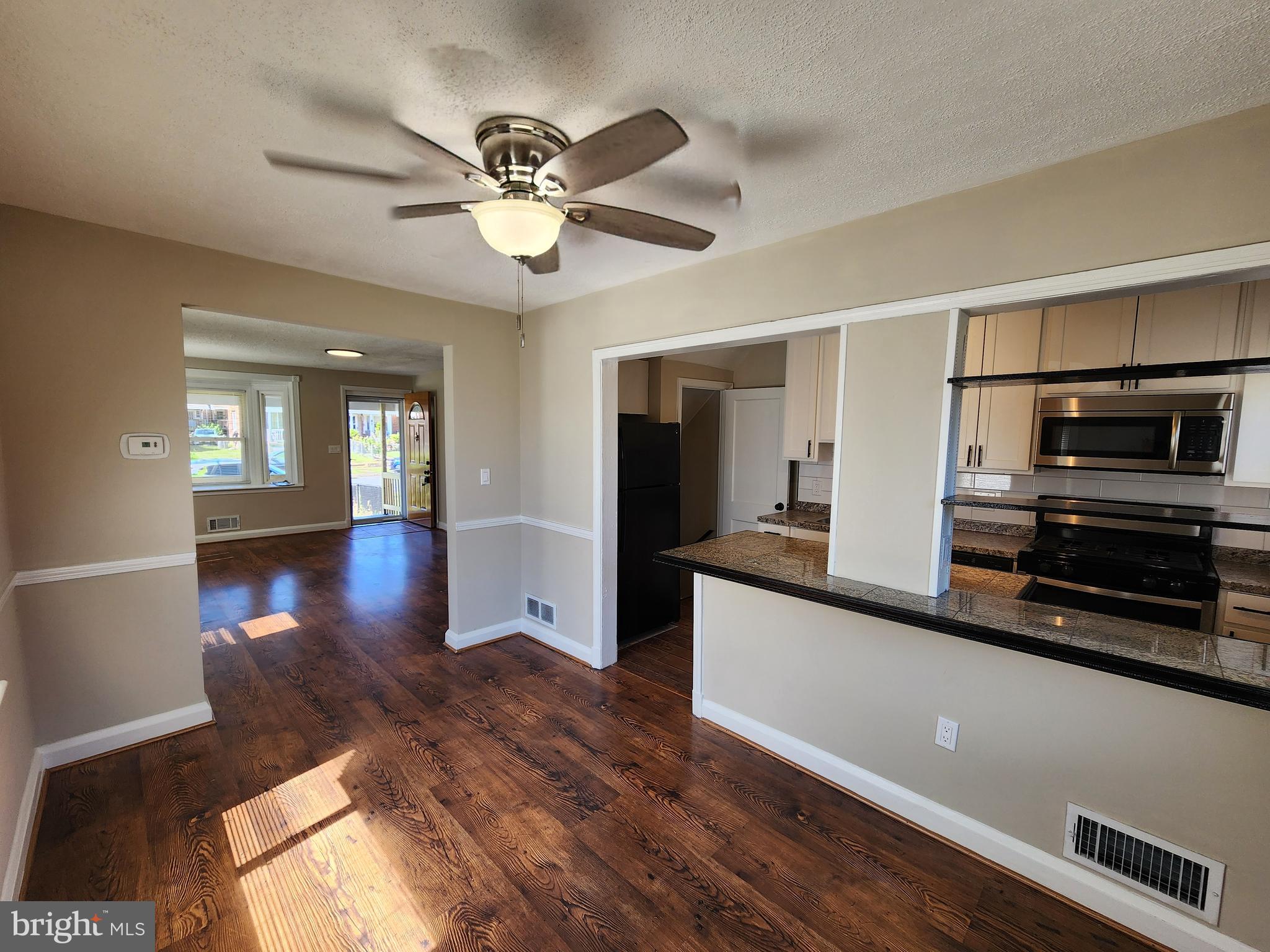 1925 Ewald Avenue Baltimore, MD 21222 - Photo 6 of 29 a kitchen with stainless steel appliances granite countertop a refrigerator a sink dishwasher a stove and white countertops with wooden floor
