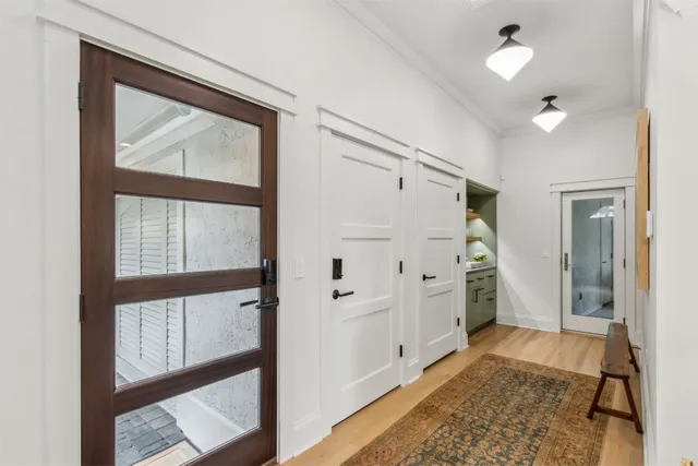 a bathroom with a glass door shower and a sink