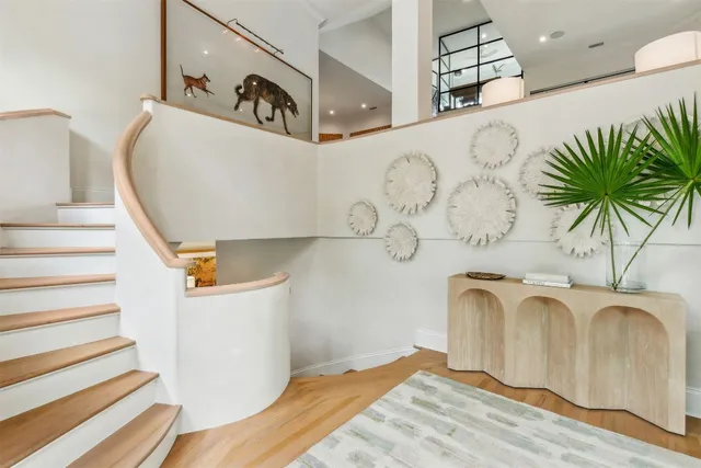 a view of a livingroom with furniture and staircase