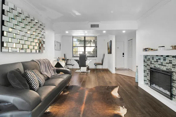 a living room with furniture a fireplace and a large window