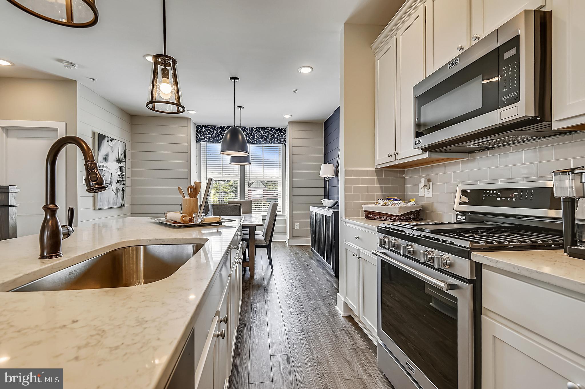 16606 Breezeway Alley Accokeek, MD 20607 - Photo 12 of 34 a kitchen with a stove a sink and a microwave