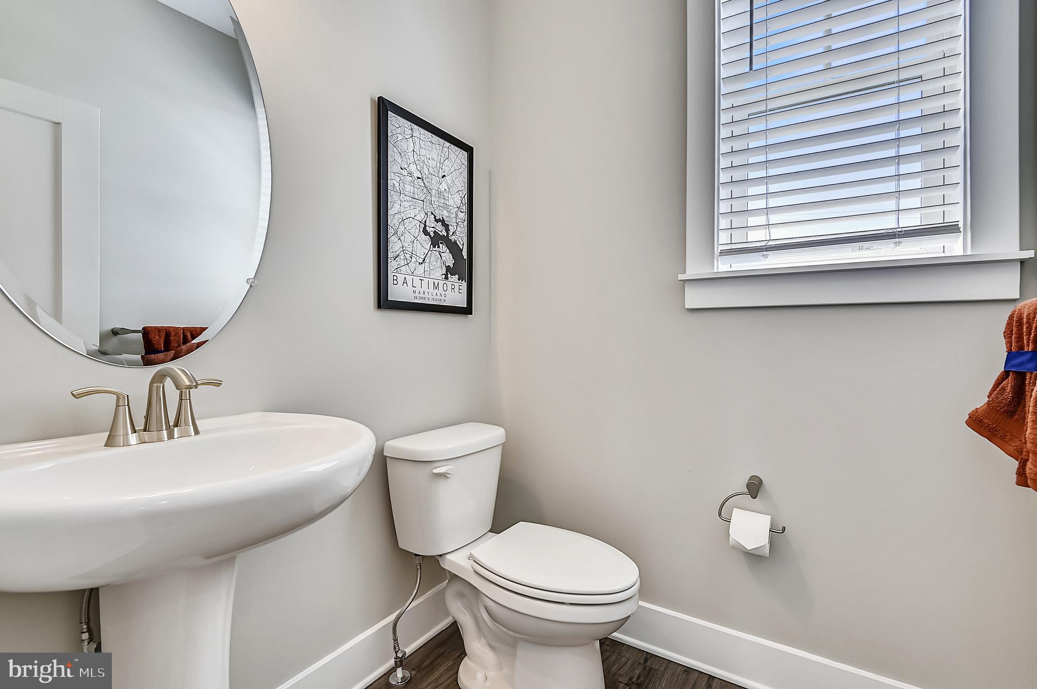 16606 Breezeway Alley Accokeek, MD 20607 - Photo 18 of 34 a bathroom with a toilet sink and mirror