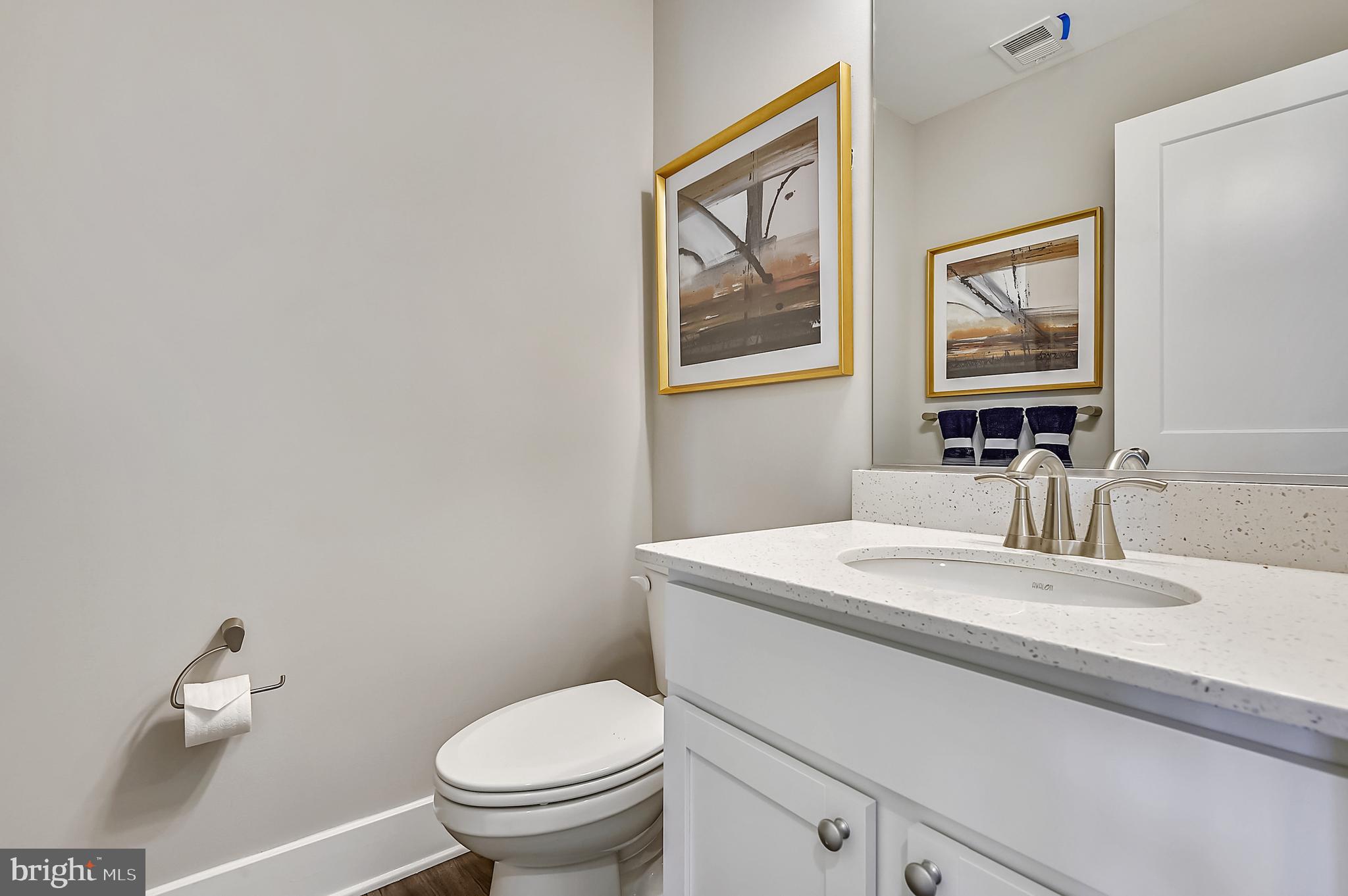 16606 Breezeway Alley Accokeek, MD 20607 - Photo 19 of 34 a bathroom with a toilet a sink and mirror
