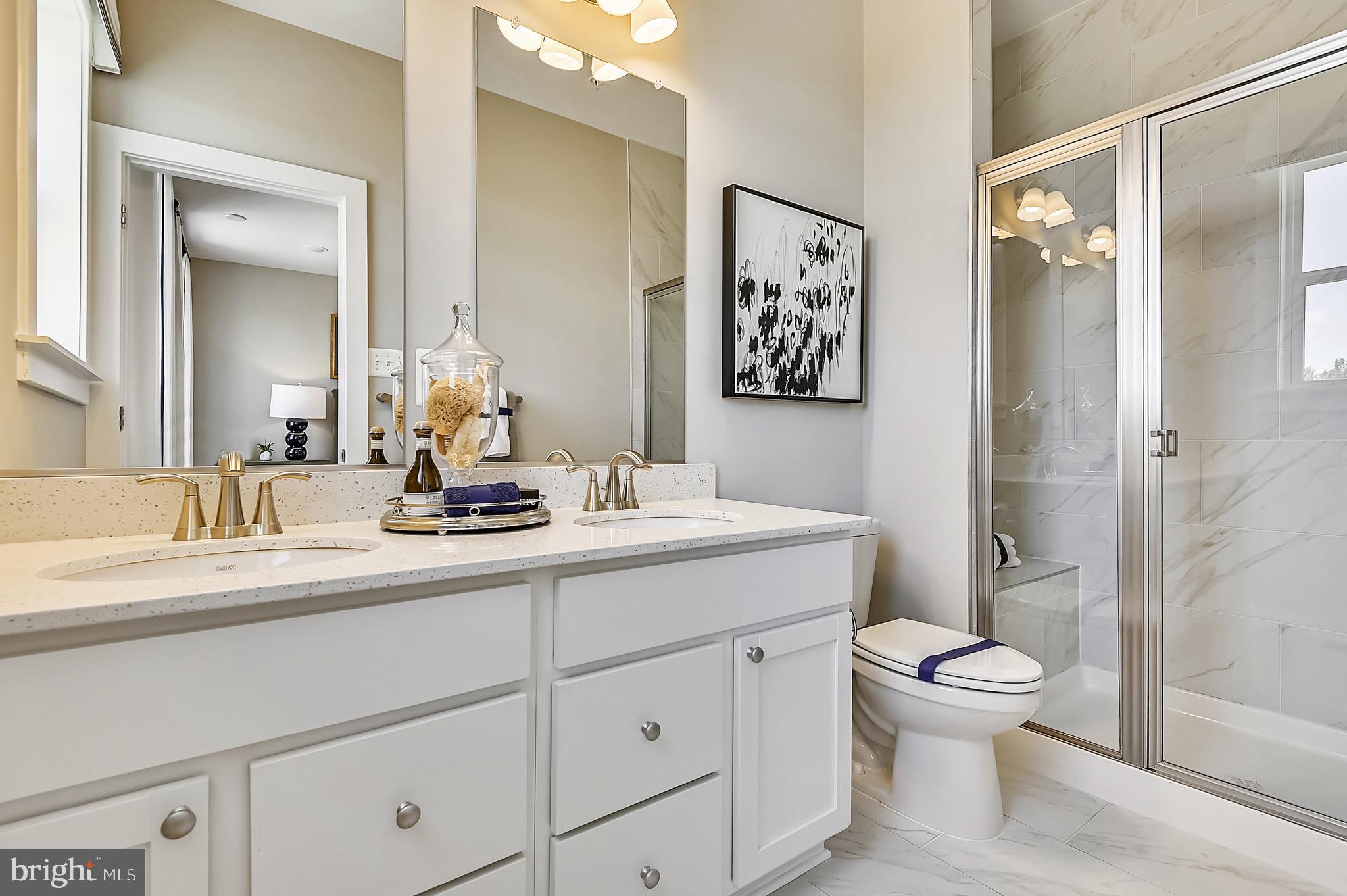 16606 Breezeway Alley Accokeek, MD 20607 - Photo 27 of 34 a bathroom with a toilet sink and shower