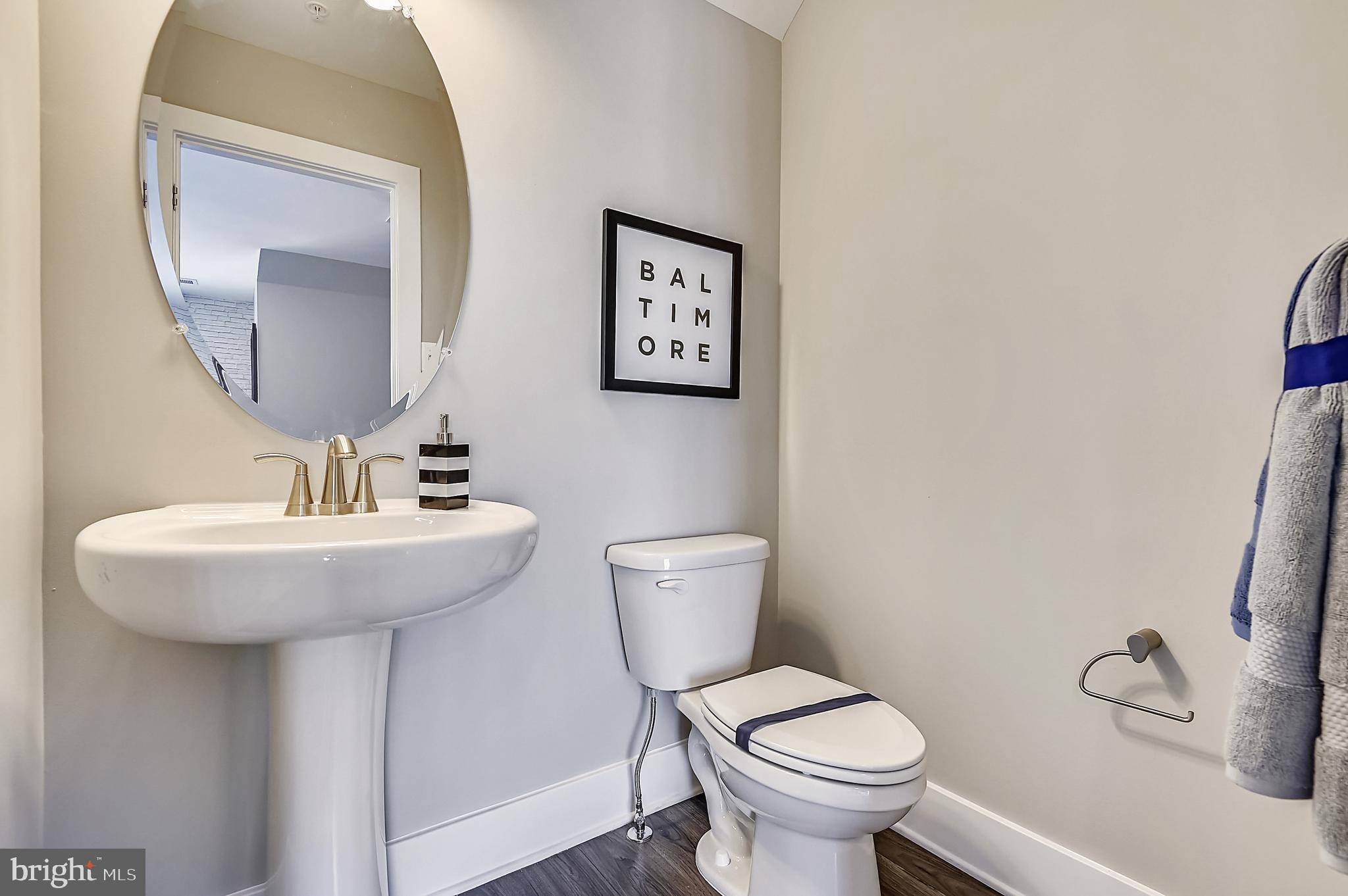 16606 Breezeway Alley Accokeek, MD 20607 - Photo 34 of 34 a bathroom with a toilet a sink and mirror