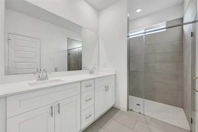 a bathroom with double sink and a mirror