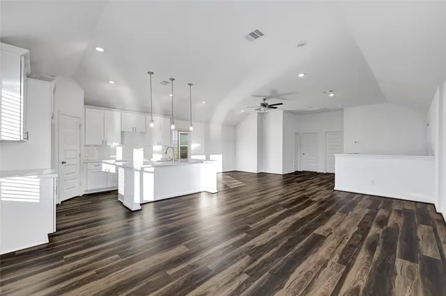 a view of kitchen and hall with wooden floor