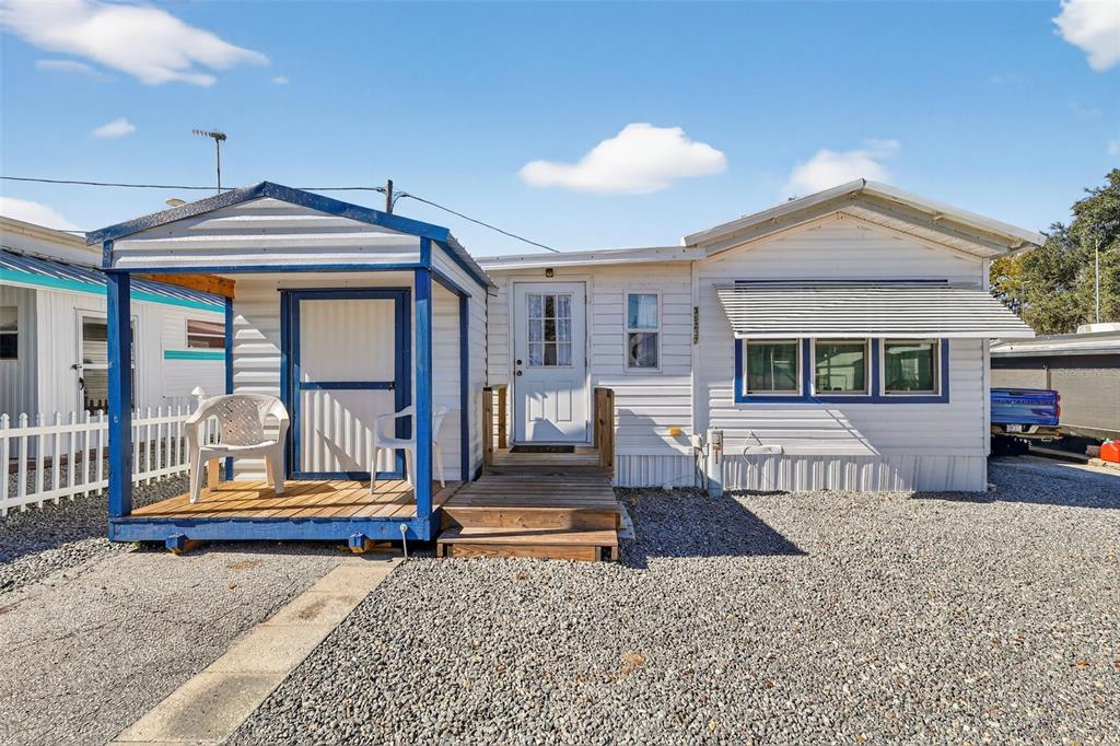 38237 Oriole Way Leesburg, FL 34788 - Photo 1 of 25 a front view of a house with wooden floor and a porch