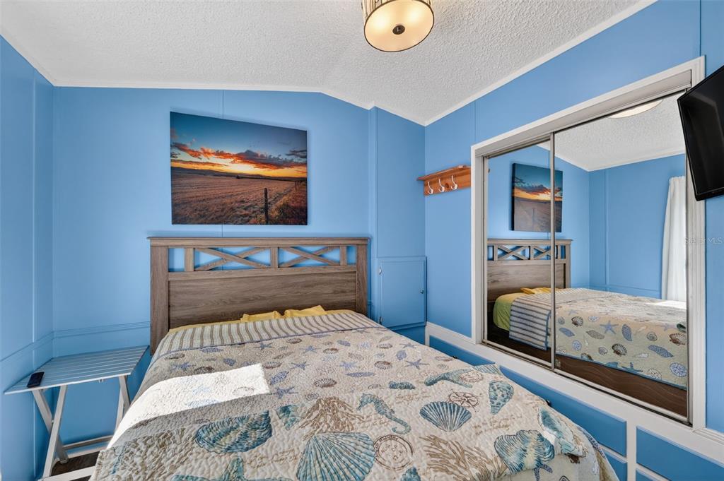 38237 Oriole Way Leesburg, FL 34788 - Photo 14 of 25 a bedroom with a bed and a flat screen tv