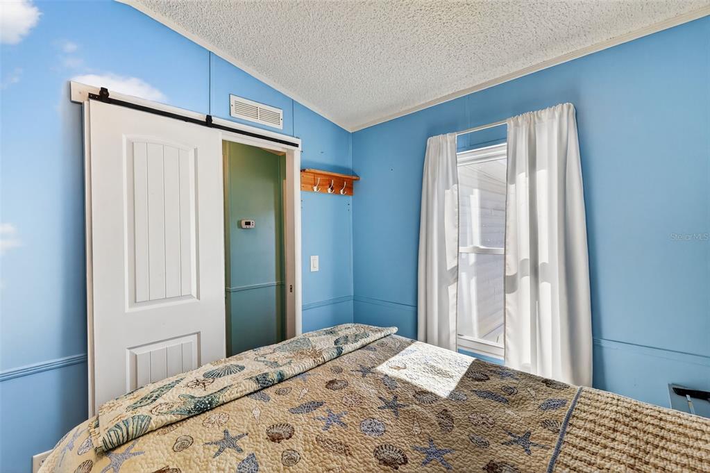 38237 Oriole Way Leesburg, FL 34788 - Photo 15 of 25 a bedroom with a bed and a dresser