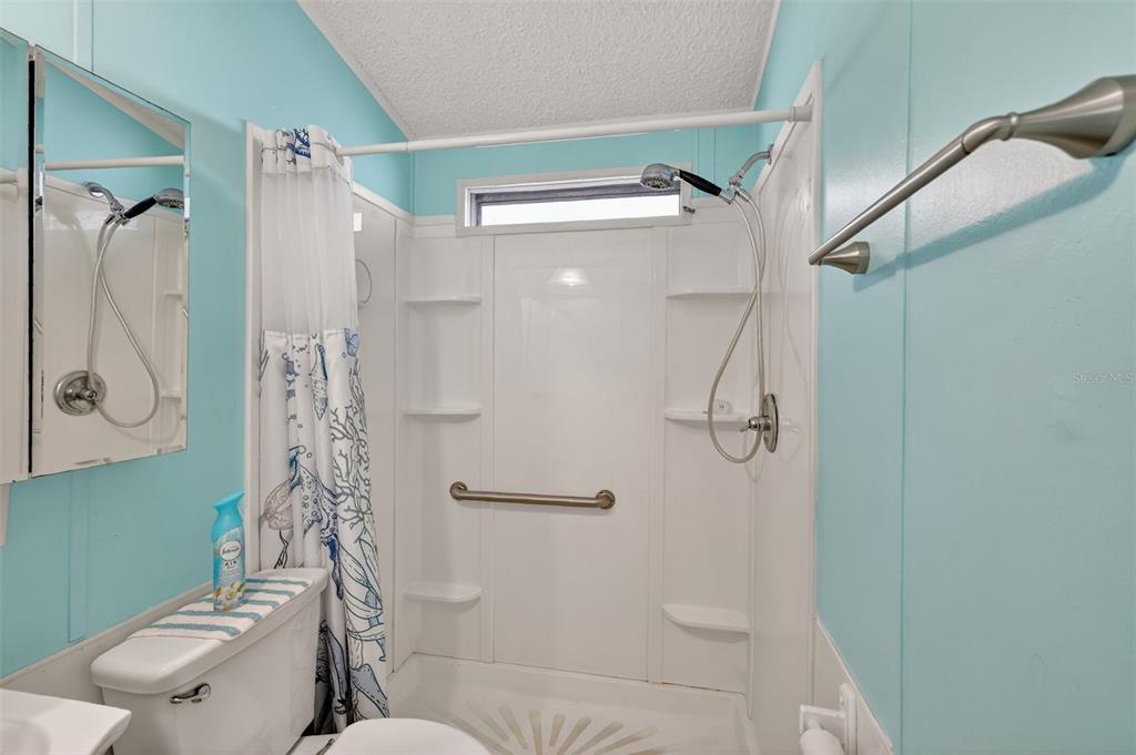 38237 Oriole Way Leesburg, FL 34788 - Photo 19 of 25 a bathroom with a shower and a toilet