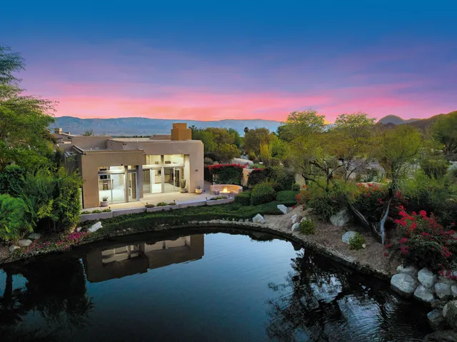 a view of a house with pool and a yard