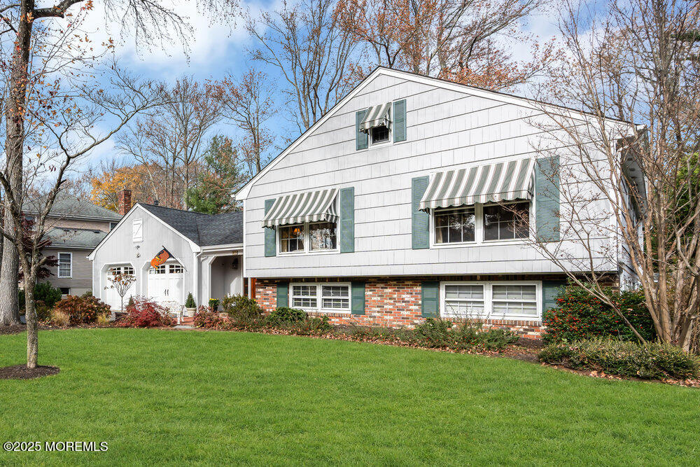 40 Brookside Lane Little Silver, NJ 07739 - Photo 1 of 43 a front view of a house with a garden