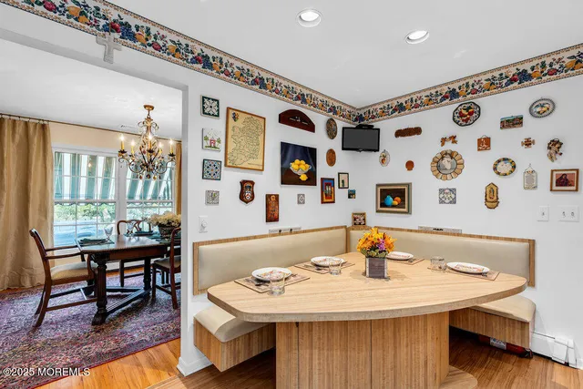 a living room with stainless steel appliances furniture a rug and a table