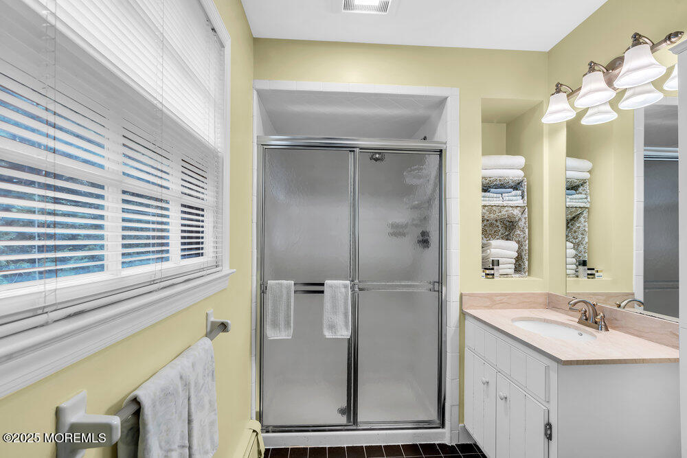 40 Brookside Lane Little Silver, NJ 07739 - Photo 20 of 43 a bathroom with a sink a mirror and a shower
