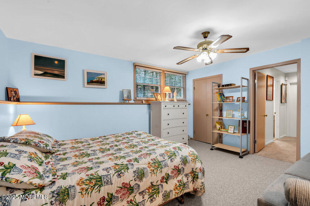 40 Brookside Lane Little Silver, NJ 07739 - Photo 29 of 43 a bedroom with a large bed and a chandelier