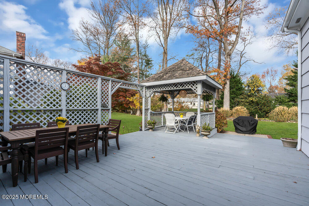 40 Brookside Lane Little Silver, NJ 07739 - Photo 30 of 43 a view of a patio with table and chairs with wooden fence and plants