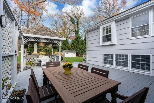 a view of a patio with table and chairs and wooden floor