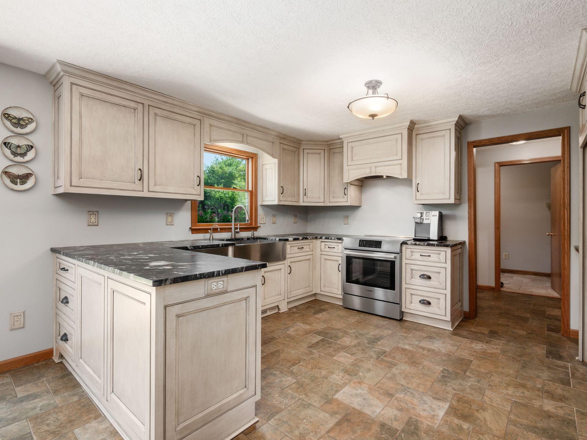 7941 Steitz Road Powell, OH 43065 - Photo 10 of 24 The kitchen has custom cabinets from Miller cabinets and beautiful leathered granite countertops. There is a hot water dispenser faucet too!