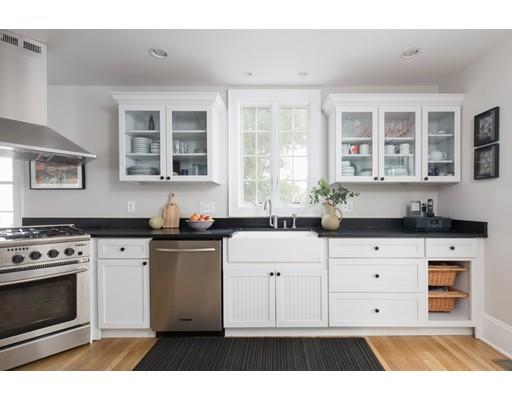 49 Grozier Road Cambridge, MA 02138 - Photo 7 of 22 a kitchen with stainless steel appliances granite countertop a stove and white cabinets