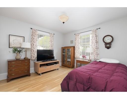 49 Grozier Road Cambridge, MA 02138 - Photo 8 of 22 a bedroom with a bed and a flat tv screen on dresser