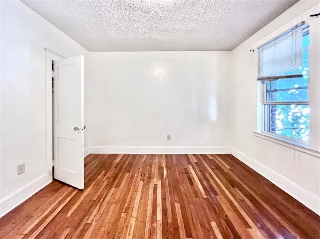 26 Chiswick Road, Unit 6 Boston, MA 02135 - Photo 21 of 24 a view of wooden floor in a room