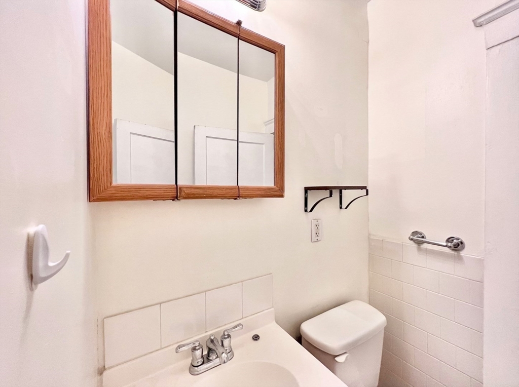 26 Chiswick Road, Unit 6 Boston, MA 02135 - Photo 8 of 24 a bathroom with a toilet sink and shower