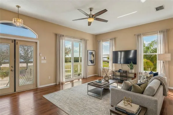 a view of room with wooden floor and ceiling fan