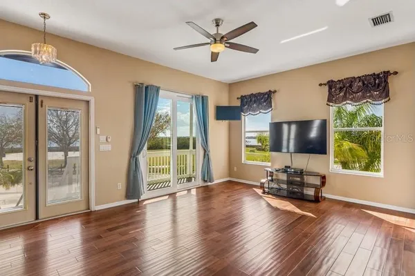 a living room with furniture wooden floor and a window