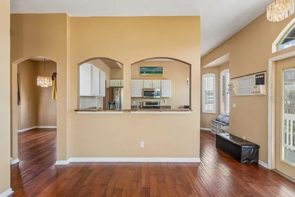 a large kitchen with stainless steel appliances granite countertop a stove a sink and a microwave