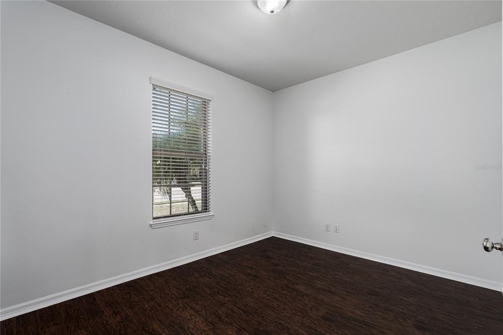 6026 100th Avenue East Parrish, FL 34219 - Photo 11 of 51 wooden floor in an empty room with a window