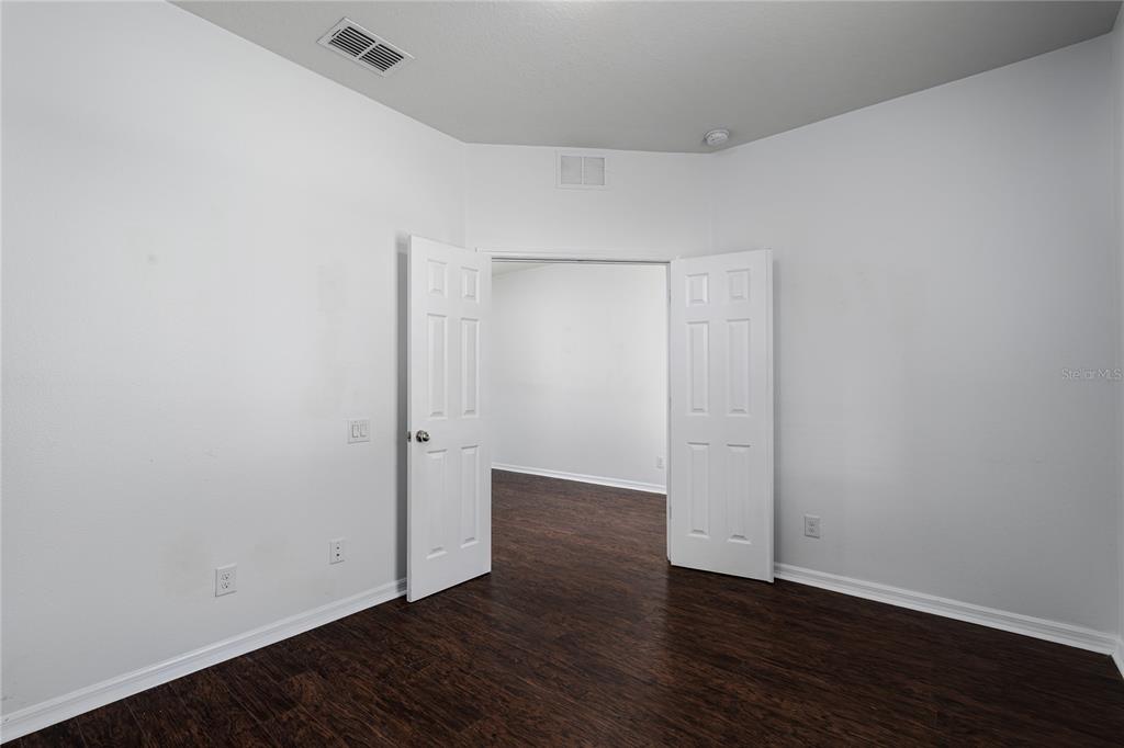 6026 100th Avenue East Parrish, FL 34219 - Photo 12 of 51 a view of an empty room with wooden floor