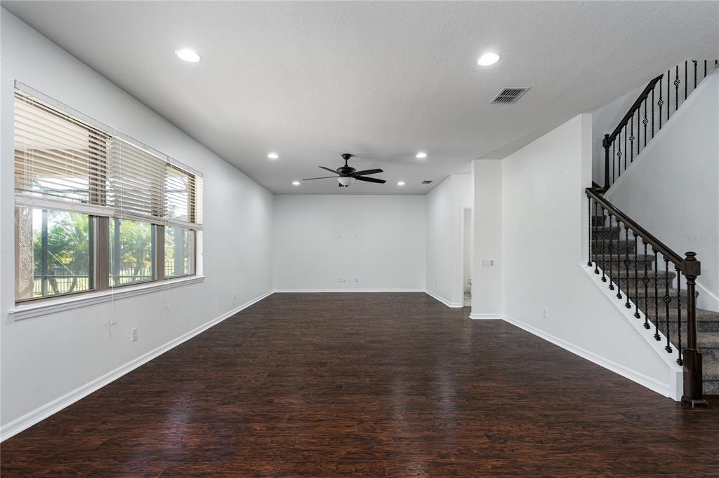 6026 100th Avenue East Parrish, FL 34219 - Photo 2 of 51 a view of an empty room with wooden floor and a window