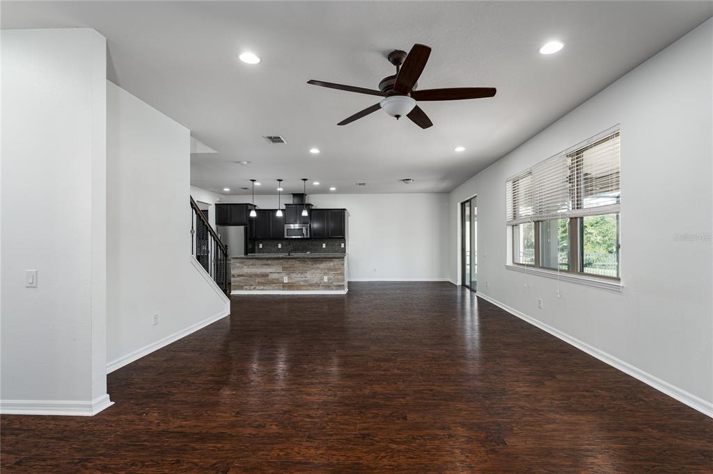 6026 100th Avenue East Parrish, FL 34219 - Photo 3 of 51 a view of a livingroom with a ceiling fan and wooden floor