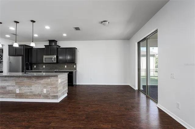 a view of kitchen with microwave and cabinets