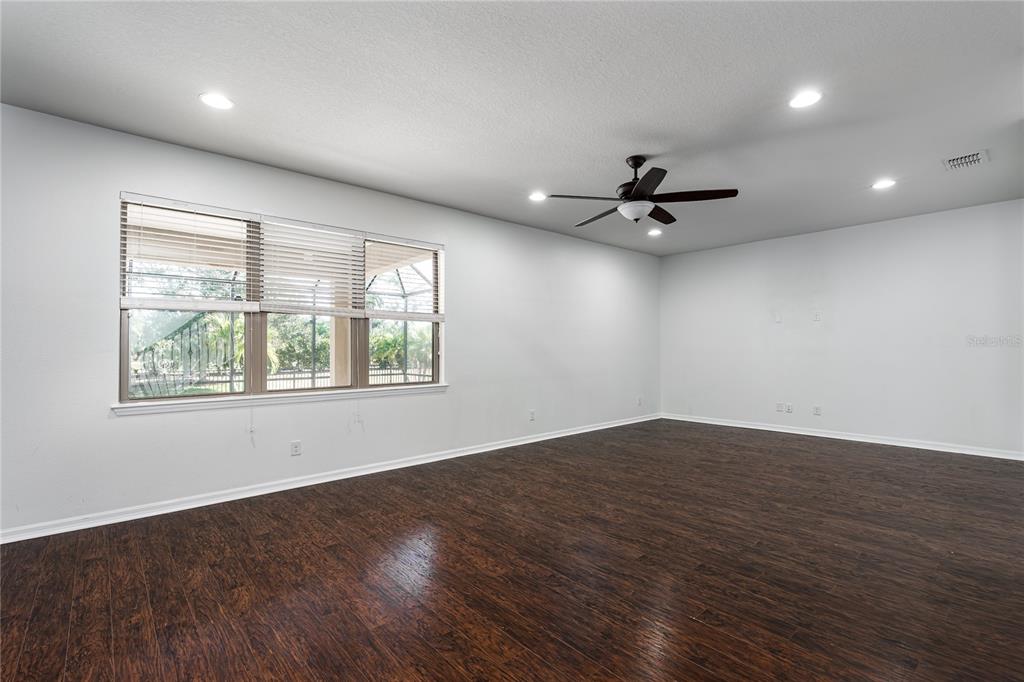 6026 100th Avenue East Parrish, FL 34219 - Photo 8 of 51 an empty room with wooden floor and windows