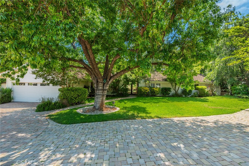 24952 Kit Carson Road Hidden Hills, CA 91302 - Photo 1 of 1 a front view of a house with a yard and trees