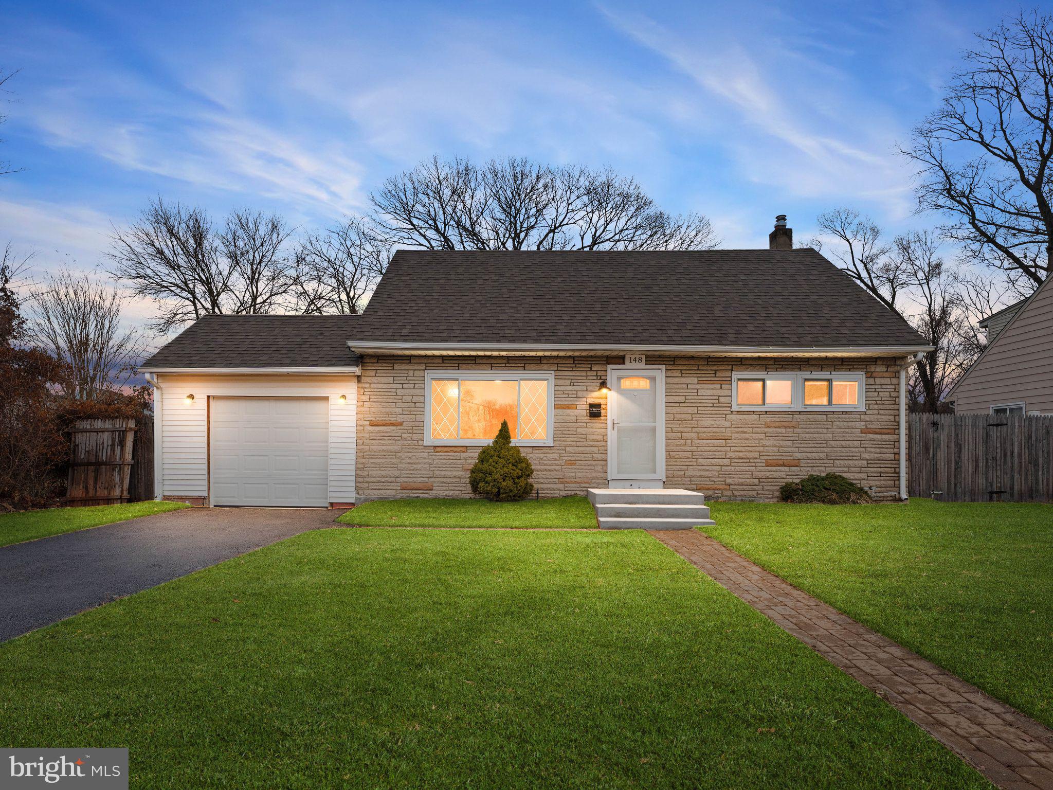 148 Lincoln Road Wenonah, NJ 08090 - Photo 1 of 40 a front view of a house with a yard and garage