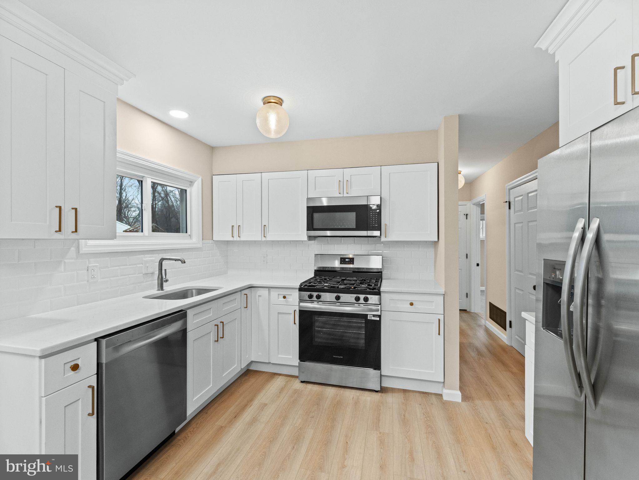 148 Lincoln Road Wenonah, NJ 08090 - Photo 11 of 40 a kitchen with a sink cabinets stainless steel appliances and a window