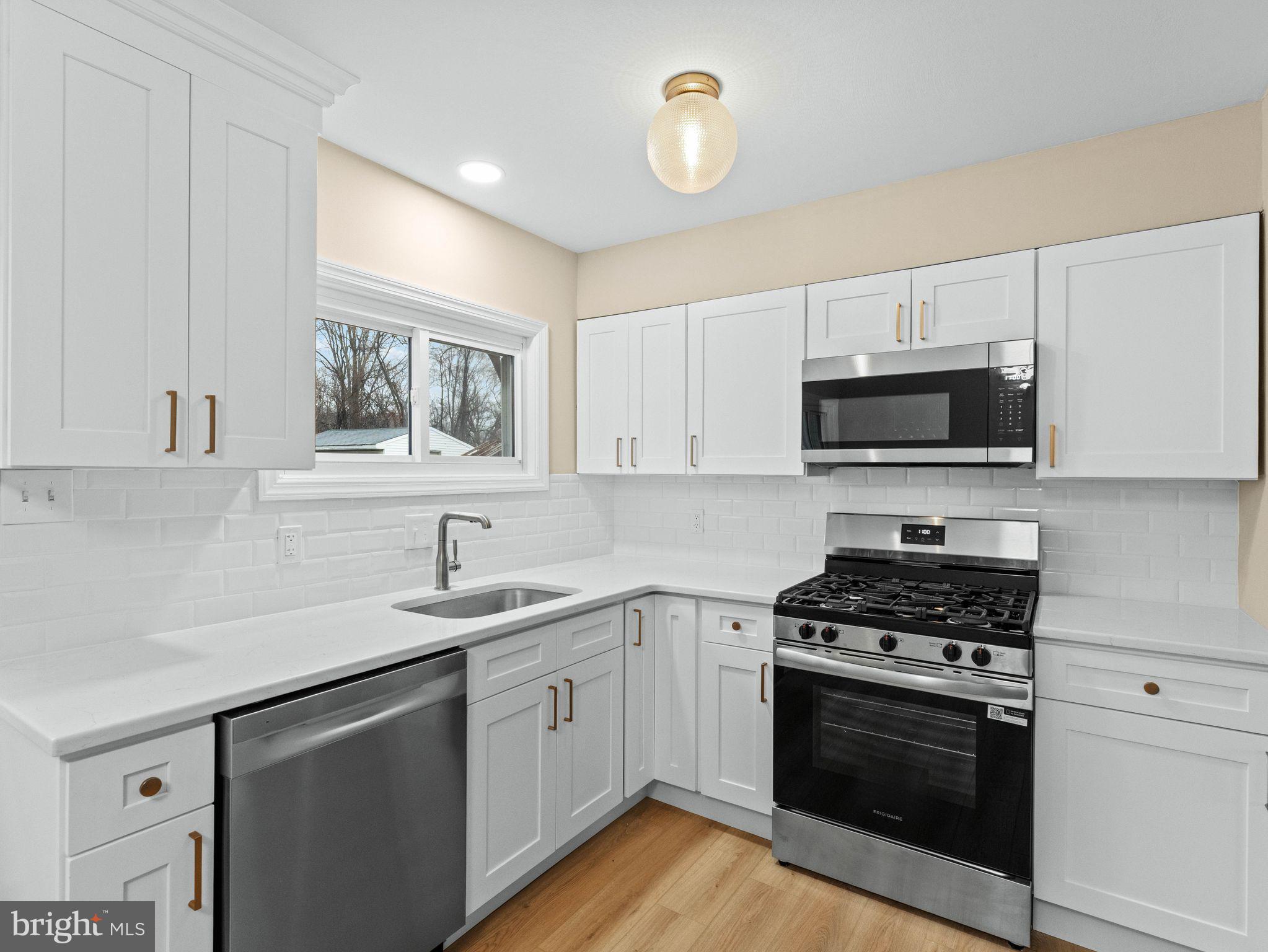 148 Lincoln Road Wenonah, NJ 08090 - Photo 13 of 40 a kitchen with sink a microwave and cabinets