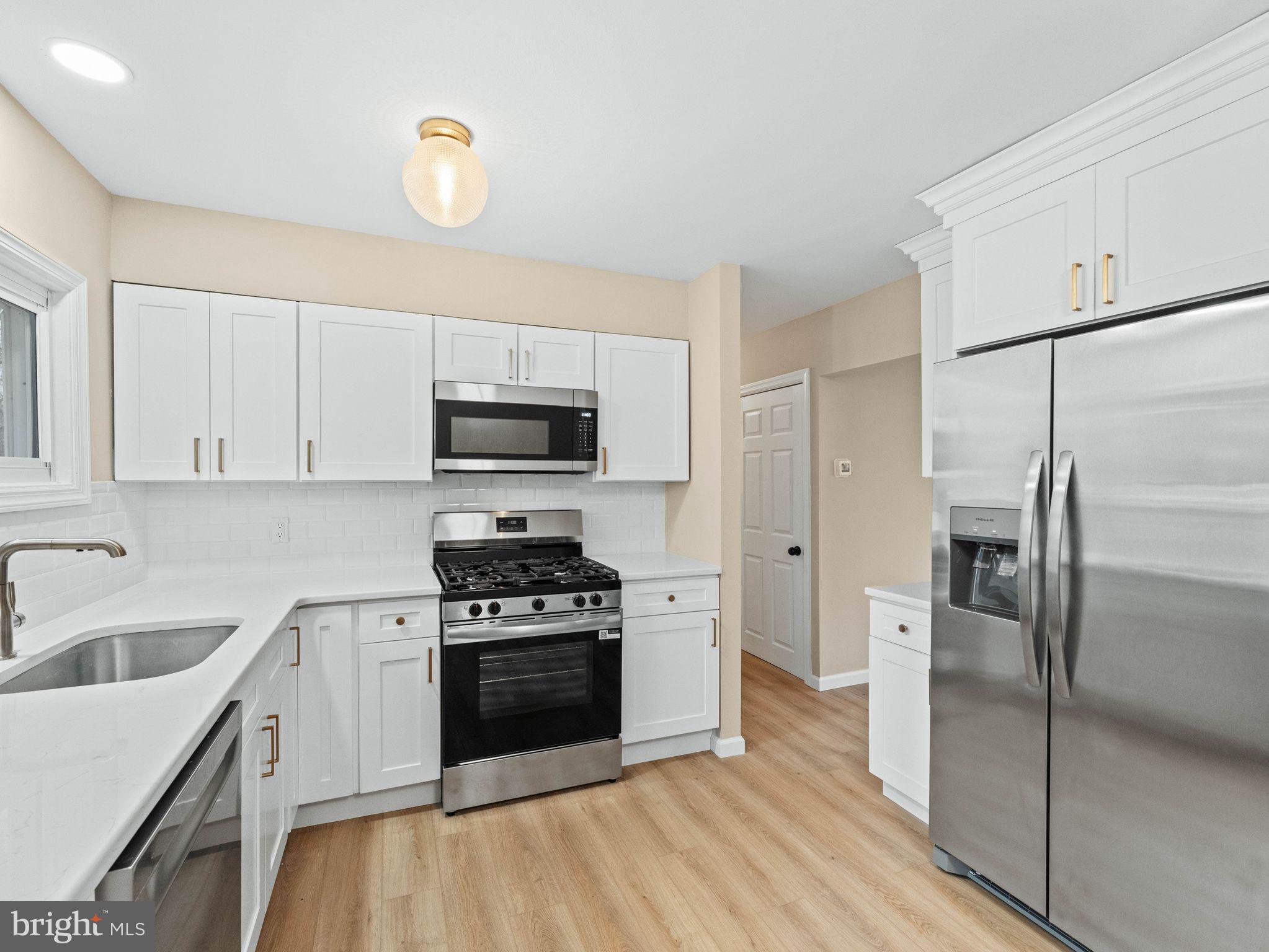 148 Lincoln Road Wenonah, NJ 08090 - Photo 14 of 40 a kitchen with a refrigerator stove and microwave