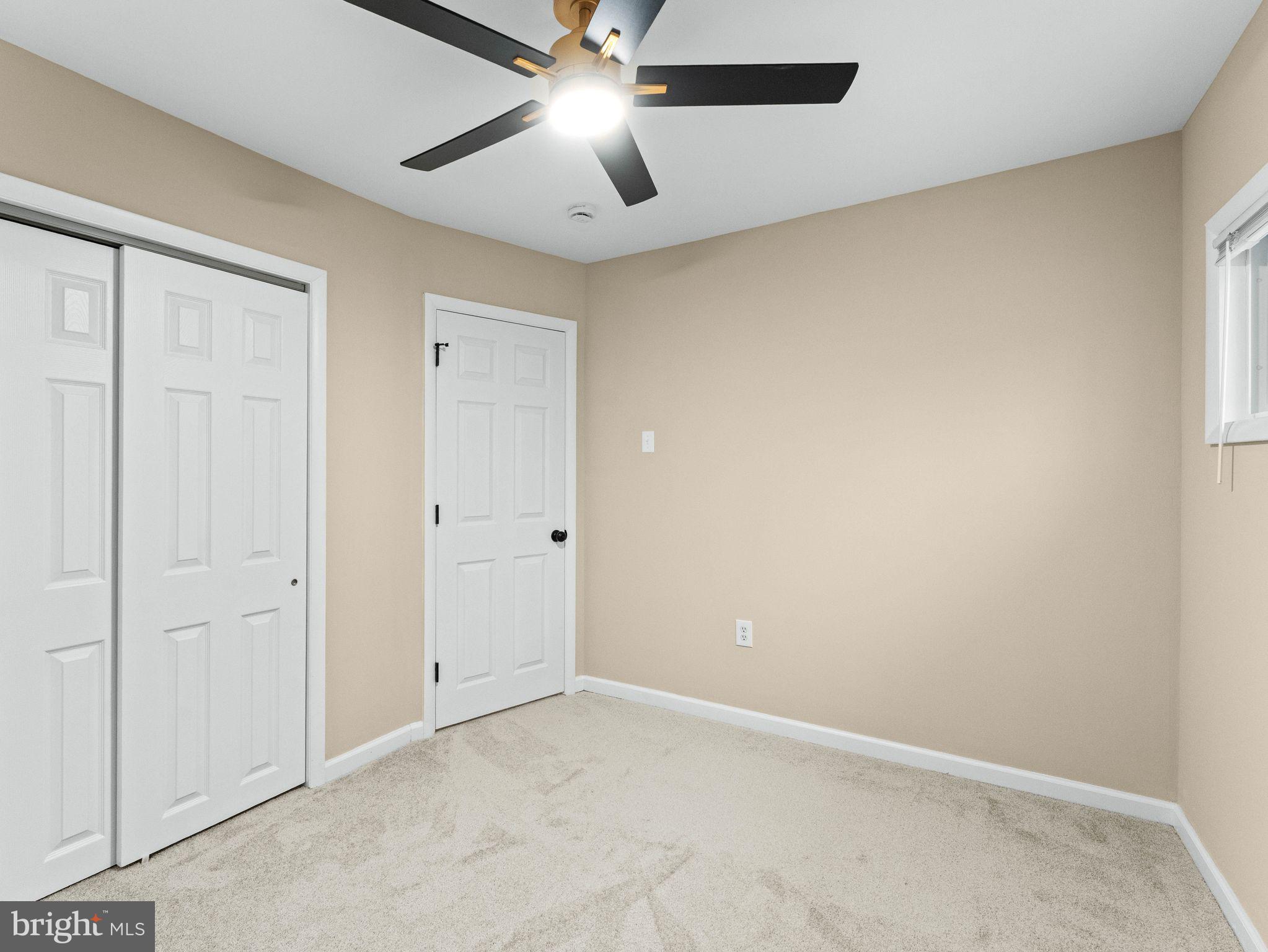 148 Lincoln Road Wenonah, NJ 08090 - Photo 17 of 40 an empty room with a ceiling fan and a window